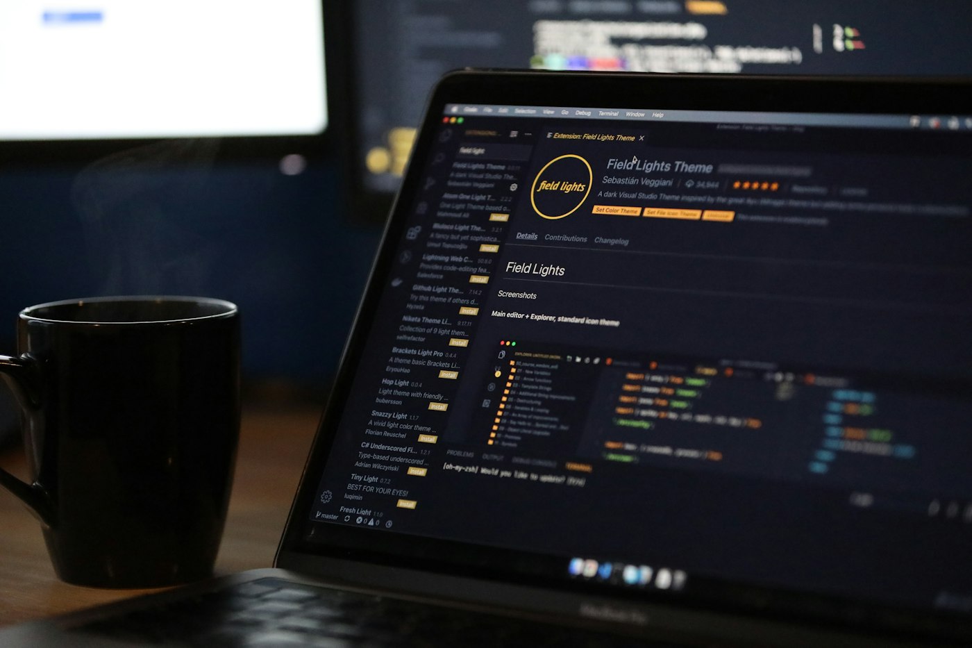 Ordinateur portable affichant du code à côté d’une tasse